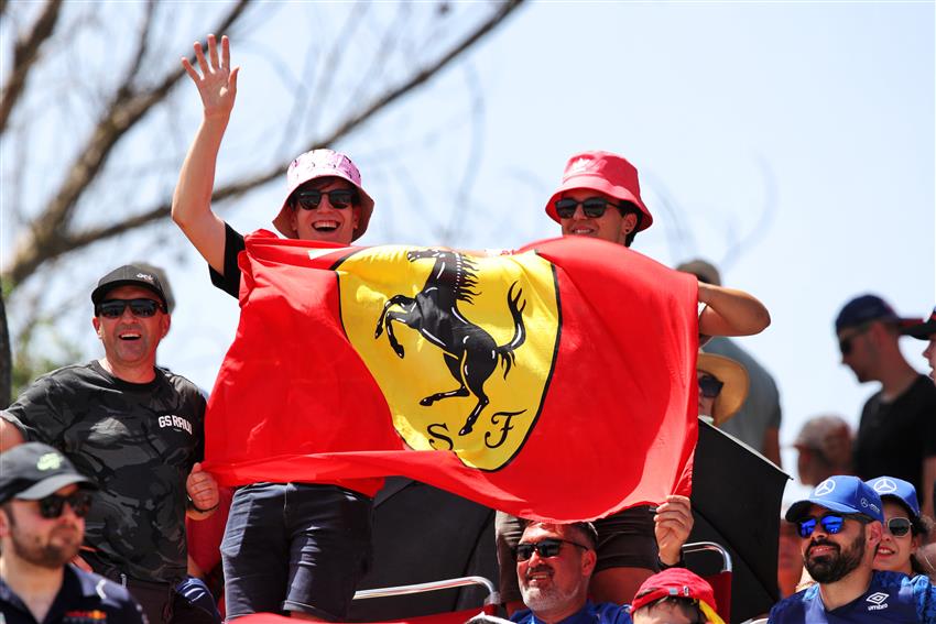 Two boys holding Ferrari flags